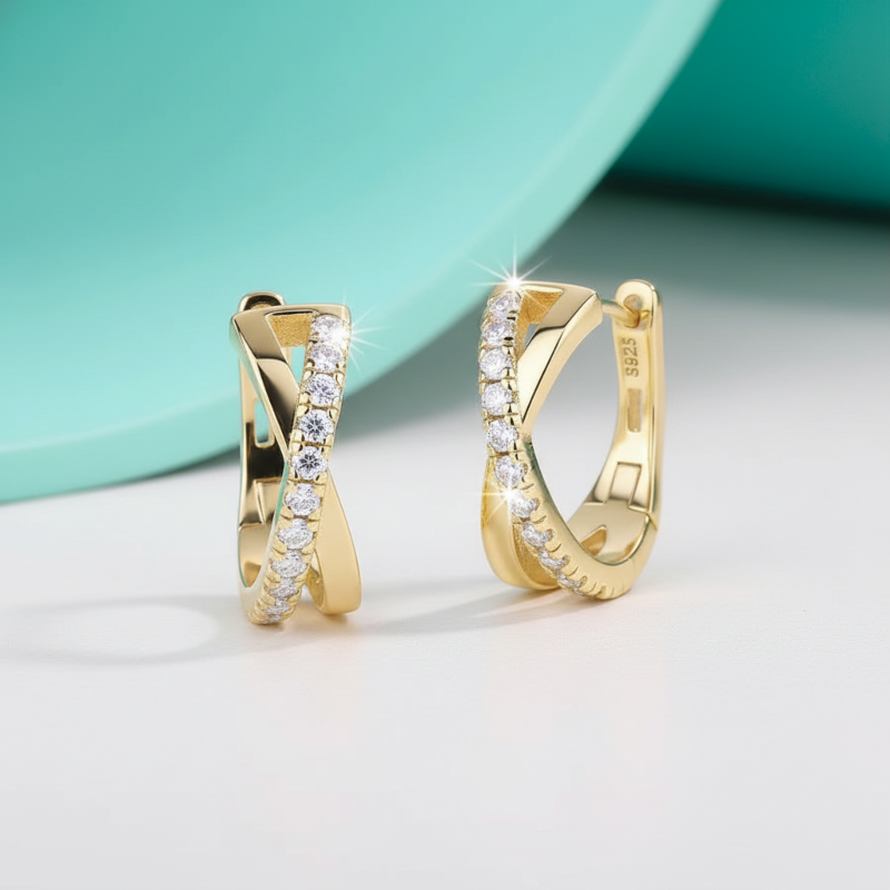 Gold hoop earrings with diamond accents on a light background