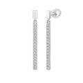 Pair of silver earrings with clear gemstones on a light gray background