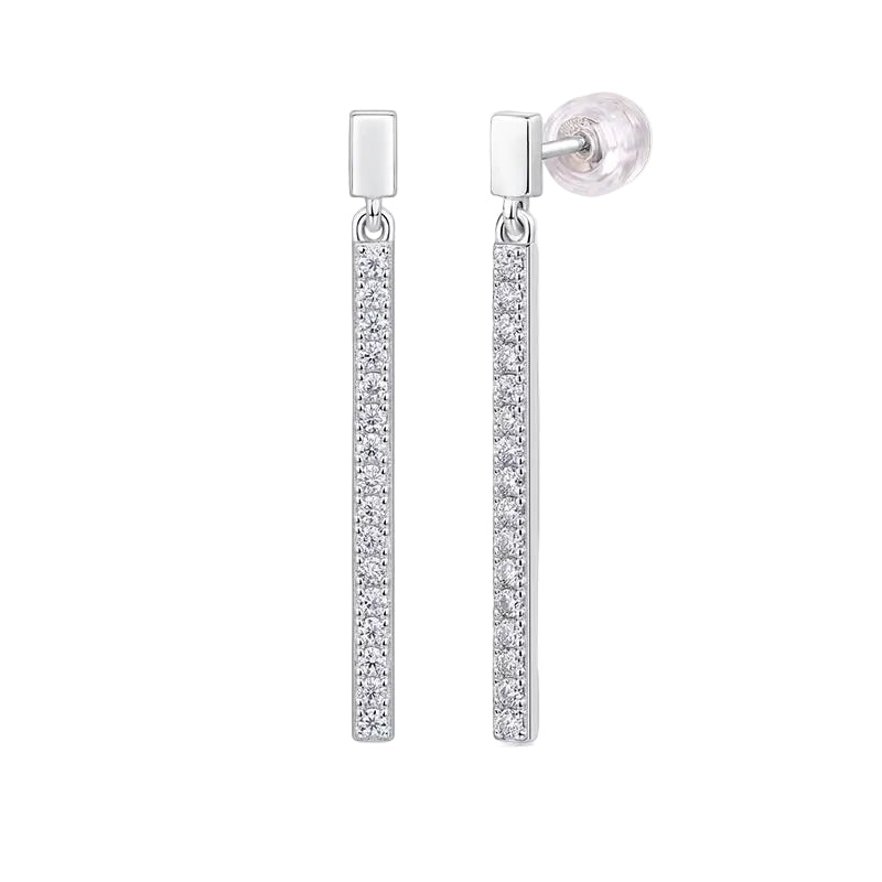 Pair of silver earrings with clear gemstones on a light gray background
