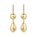 Gold earrings with spherical and teardrop shapes on a white background