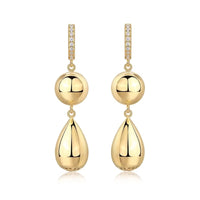 Gold earrings with spherical and teardrop shapes on a white background