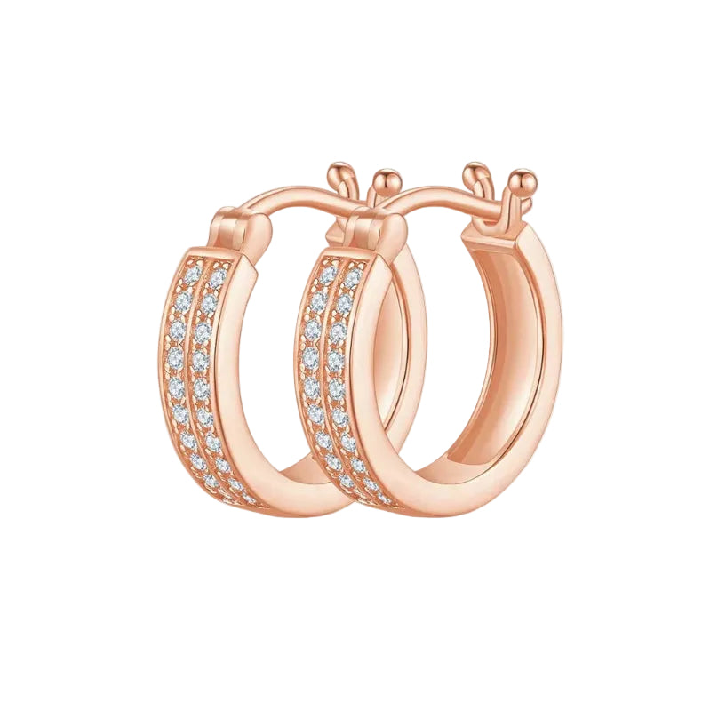 Rose gold hoop earrings with clear gemstones on a white background