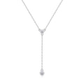 Silver necklace with three round pendants on a white background