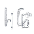 Silver earrings with clear gemstones on a white background