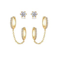 Gold hoop earrings with chain and clear gemstones on a white background