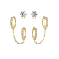 Gold hoop earrings with chain and clear gemstones on a white background