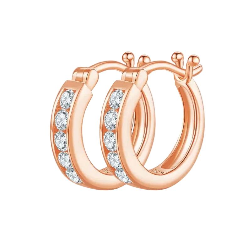 Rose gold hoop earrings with clear gemstones on a white background