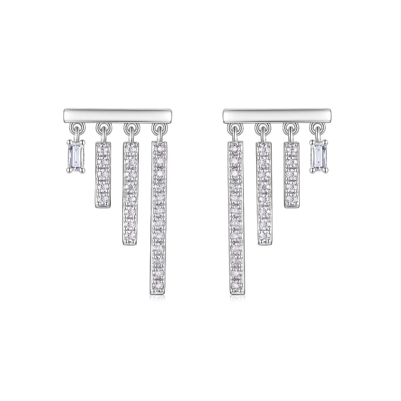Pair of silver earrings with dangling diamond-like pendants on a white background