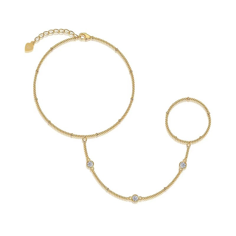 Gold bracelet with heart charm on a white background
