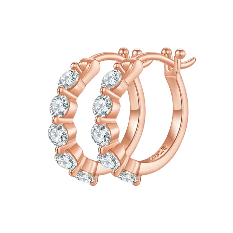 Rose gold hoop earrings with clear gemstones on a white background
