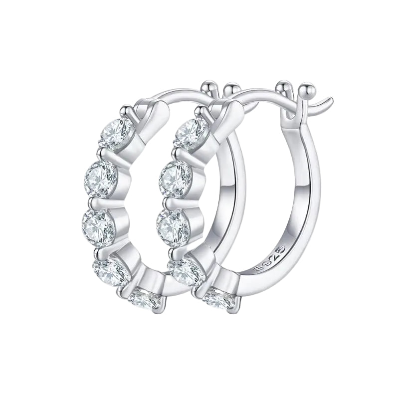 Silver hoop earrings with clear gemstones on a white background