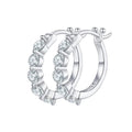 Silver hoop earrings with clear gemstones on a white background