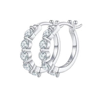 Silver hoop earrings with clear gemstones on a white background