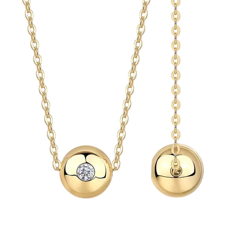 Gold necklace with spherical pendants on a white background