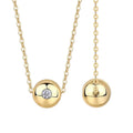 Gold necklace with spherical pendants on a white background