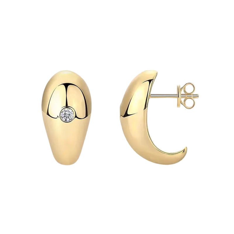 Gold hoop earrings with a central gemstone on a light beige background