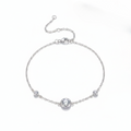 Silver bracelet with small round crystals on a white background